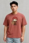 Model wearing red oversized anime t-shirt with chibi Gara and sand weight training design – funny Naruto parody gym tee